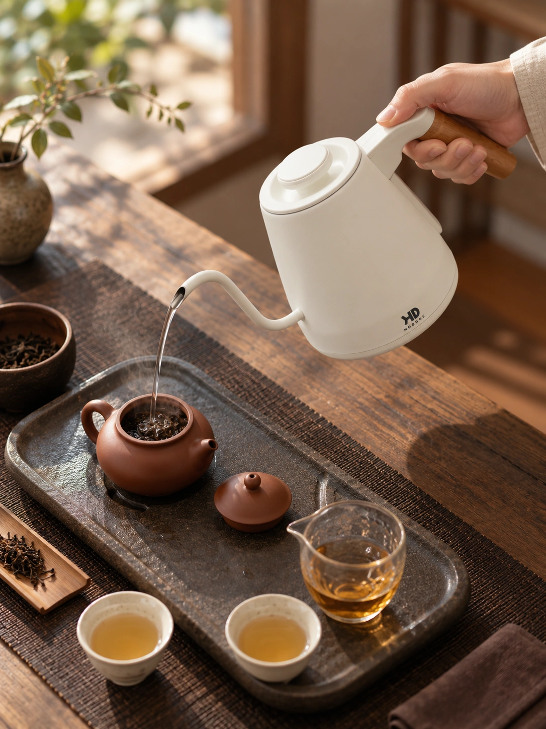 High-angle view of the kettle pouring water for tea
